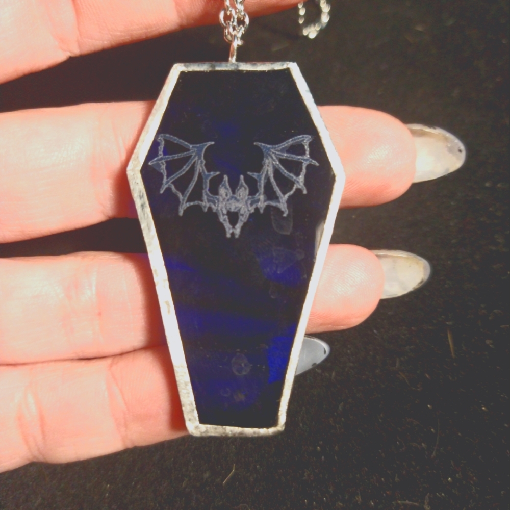 Blue stained glass coffin pendant with bat